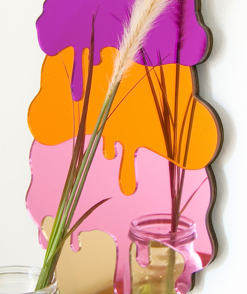 Ice cream Mirror close-up, showing the timber edges and reflecting a bouquet